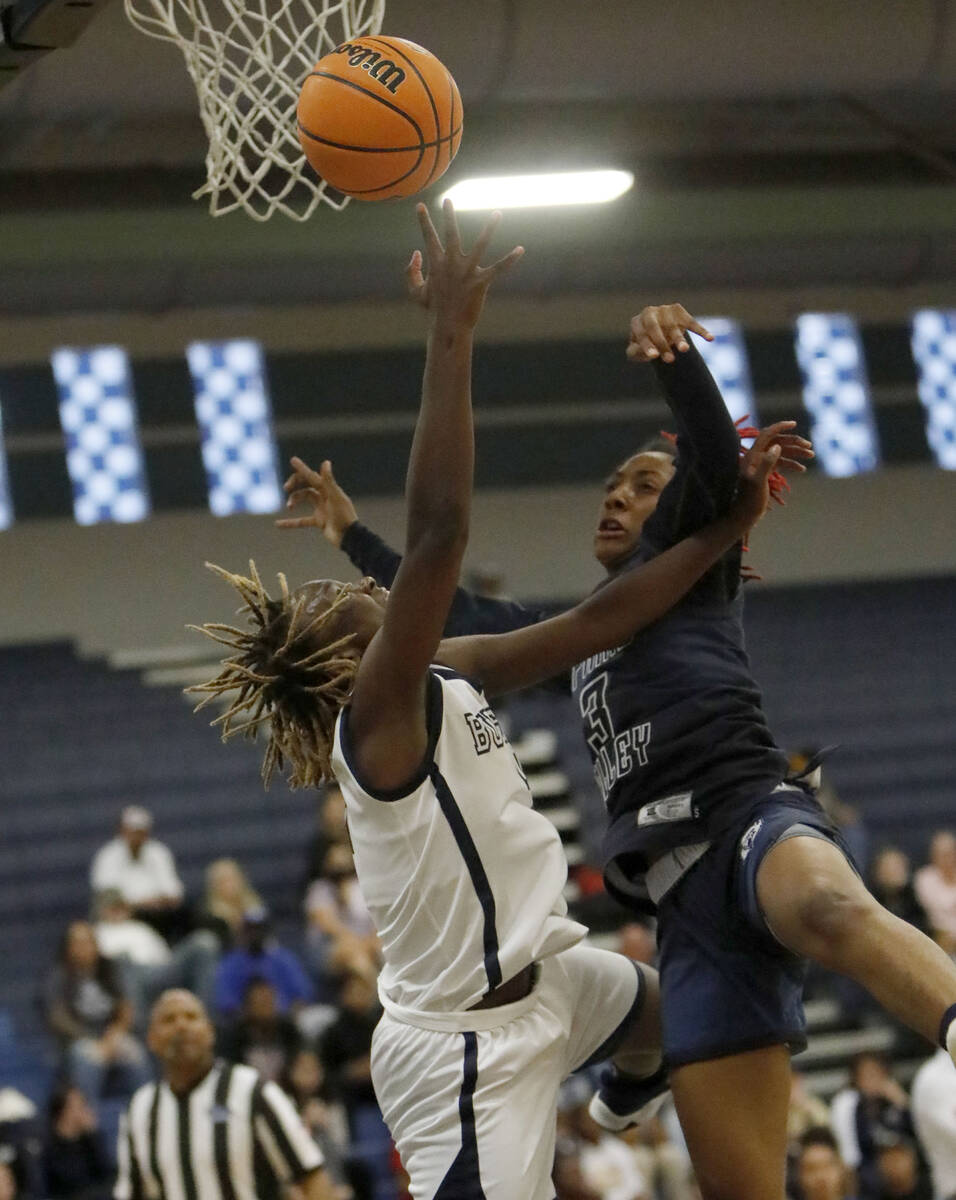 Centennial High School's Mary McMorris (4) goes to the basket as Spring Valley High School's Aa ...