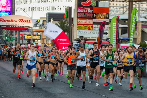 Elite runners leave the starting line during the Las Vegas Rock-N-Roll Marathon along the Strip ...
