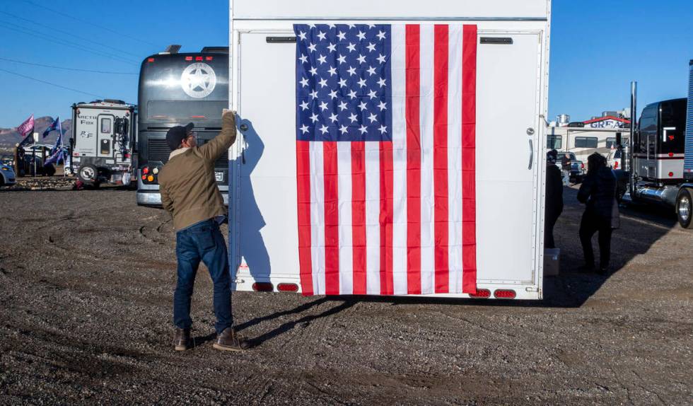 Co-organizer Jeff Hanson of Dallas hangs an American flag from the rear of his trailer as The P ...