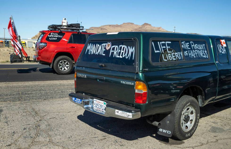 Signs on support vehicles apart of The People’s Convoy fueling up at Crazy Freds Truck S ...