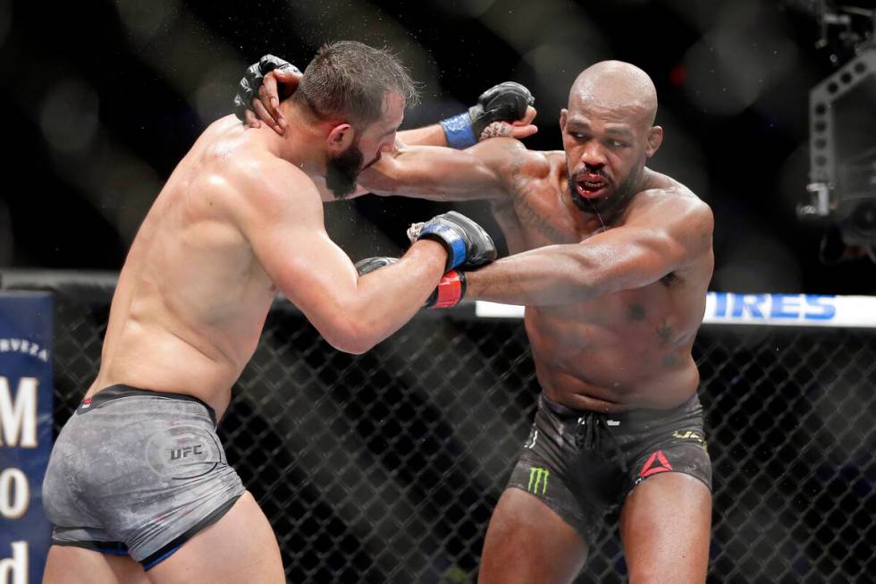 Dominick Reyes, left, and Jon Jones, right, during a light heavyweight mixed martial arts bout ...