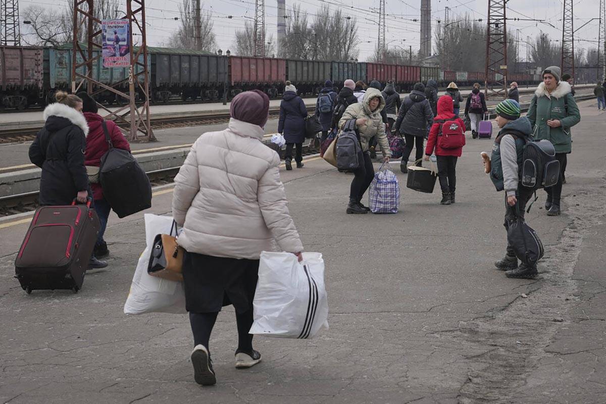 People waiting for a Kyiv bound train spread on a platform in Kostiantynivka, the Donetsk regio ...
