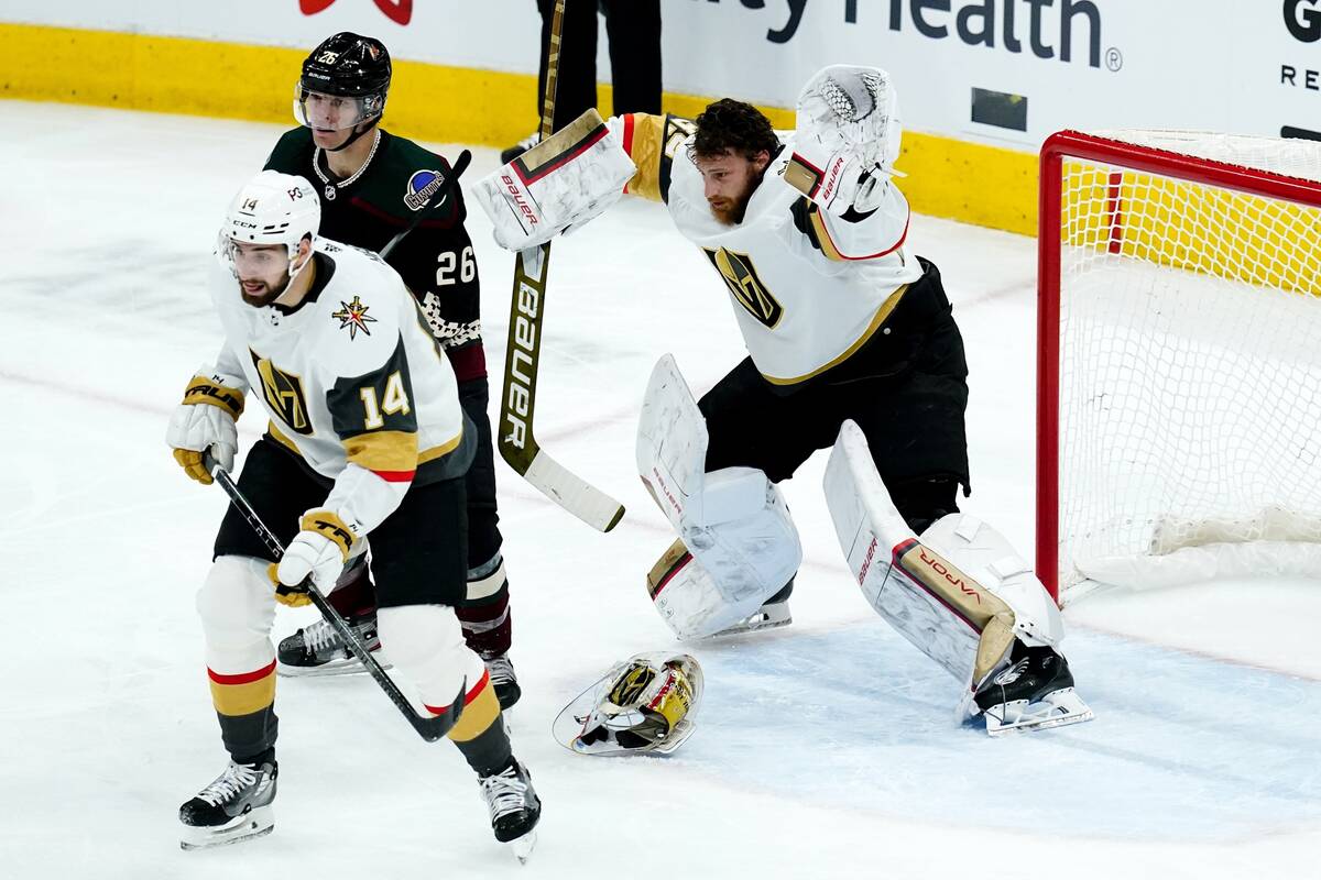 Vegas Golden Knights goaltender Laurent Brossoit, right, gives up a goal to Arizona Coyotes' Sh ...