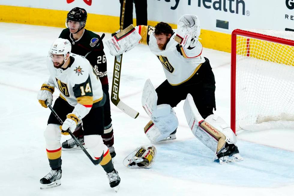 Vegas Golden Knights goaltender Laurent Brossoit, right, gives up a goal to Arizona Coyotes' Sh ...