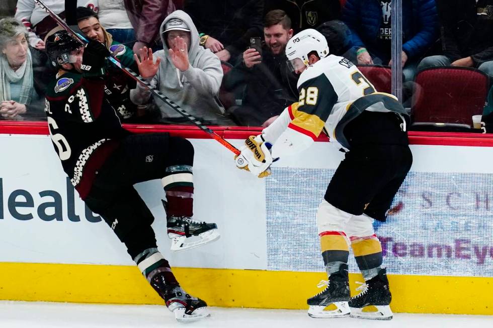 Vegas Golden Knights left wing William Carrier (28) checks Arizona Coyotes left wing Antoine Ro ...