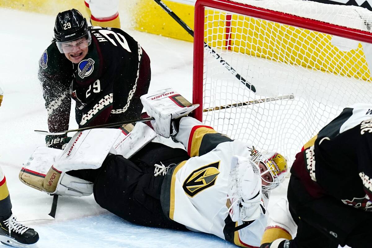 Arizona Coyotes center Barrett Hayton (29) collides with Vegas Golden Knights goaltender Lauren ...