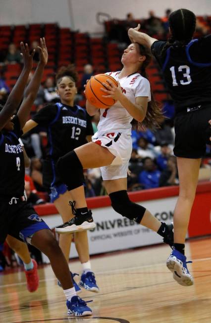 Las Vegas High School's Layla Faught (1) goest to the basket as Desert Pines High School's Tave ...
