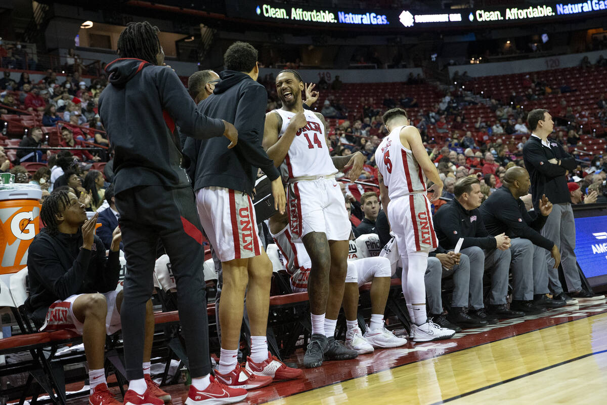 UNLV Rebels players including forward Royce Hamm Jr., center, cheer on the sidelines after thei ...