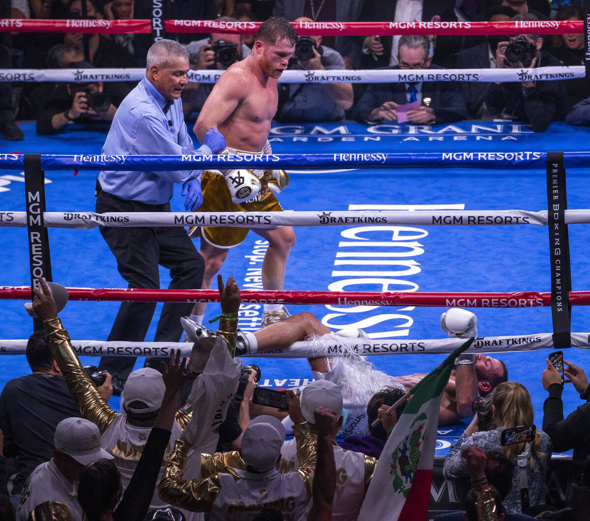 Saul "Canelo" Alvarez looks down to Caleb Plant on the canvass and out in the 11th ro ...