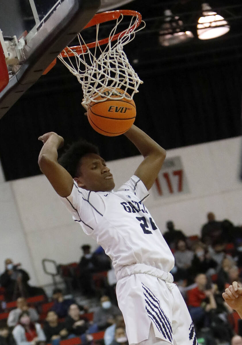 Spring Valley High School's Deasean Moreno (24) dunks during the first half of a semifinal game ...