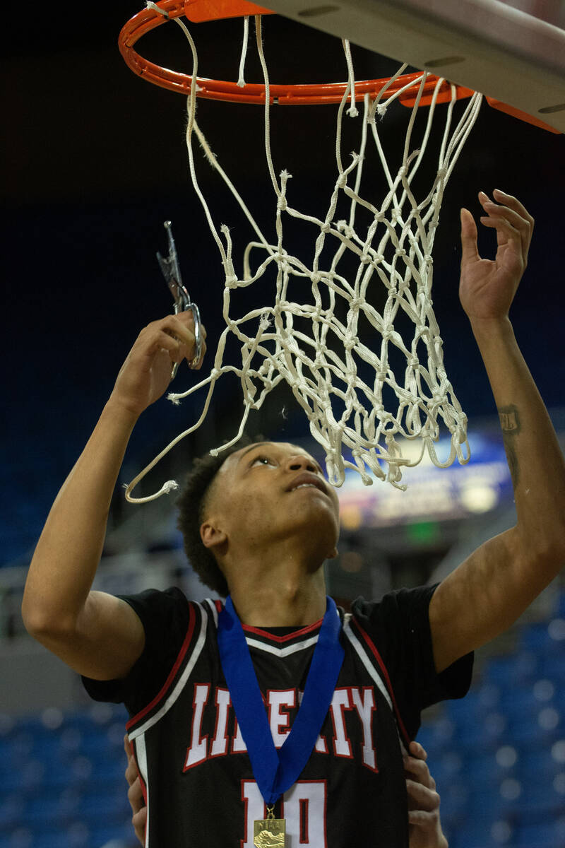 LibertyÕs King Solomon cuts down the net after beating Bishop Gorman in the NIAA Class 5A ...