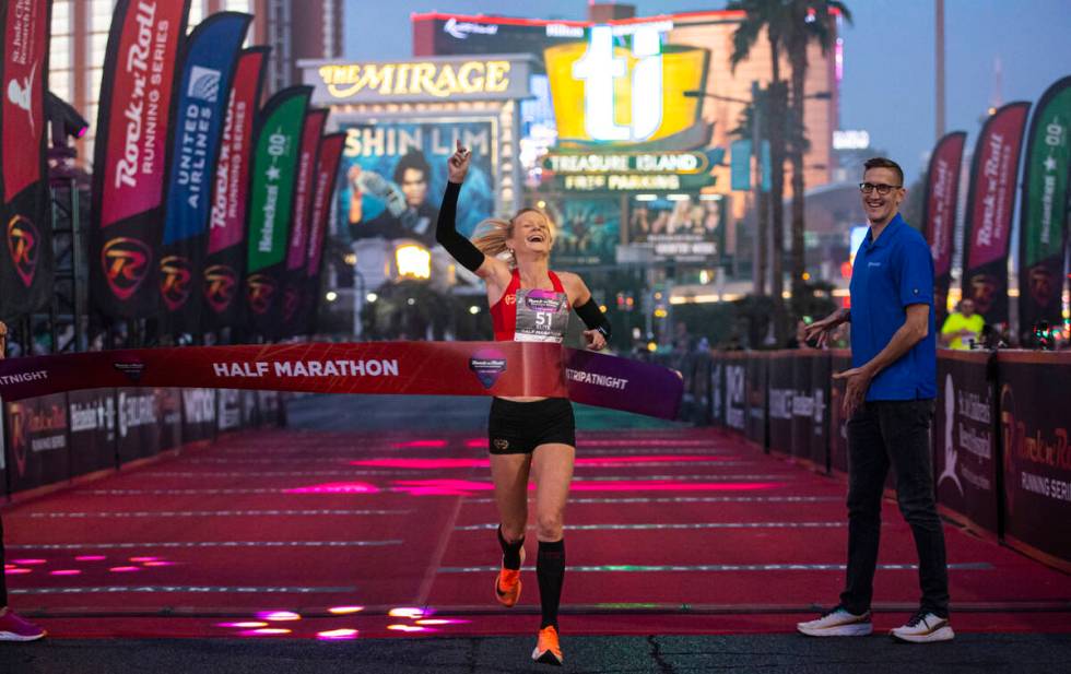 Ellie Stevens, of Las Vegas, crosses the finish line to place first in the women’s Rock ...