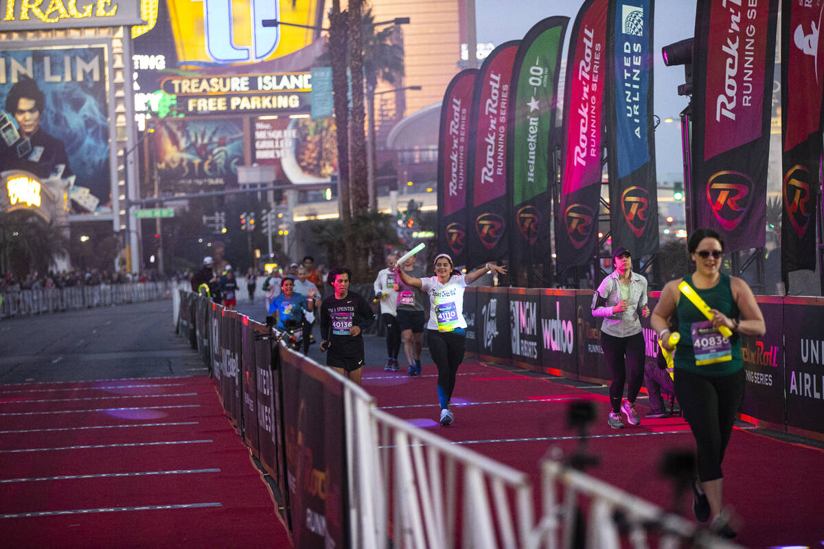 Runners approach the finish line during the Rock ‘n’ Roll Las Vegas half marathon ...