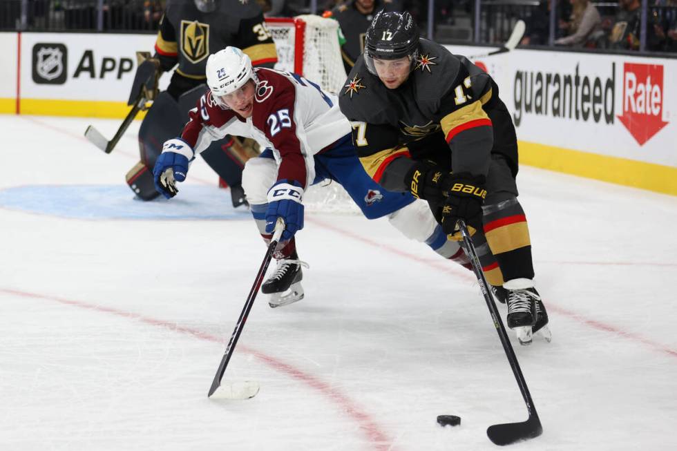 Vegas Golden Knights defenseman Ben Hutton (17) defends the puck against Colorado Avalanche rig ...