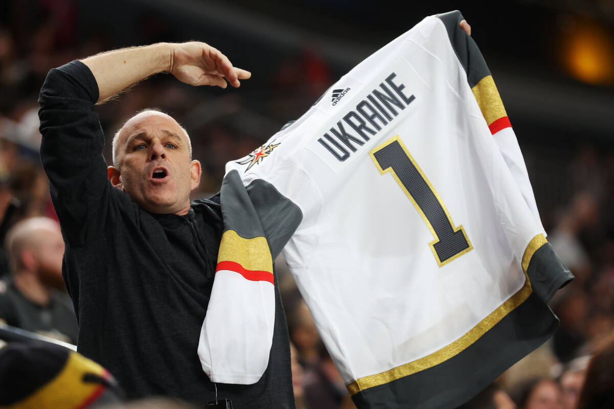 A person holds a Vegas Golden Knights jersey with Ukraine written on the back during the secon ...