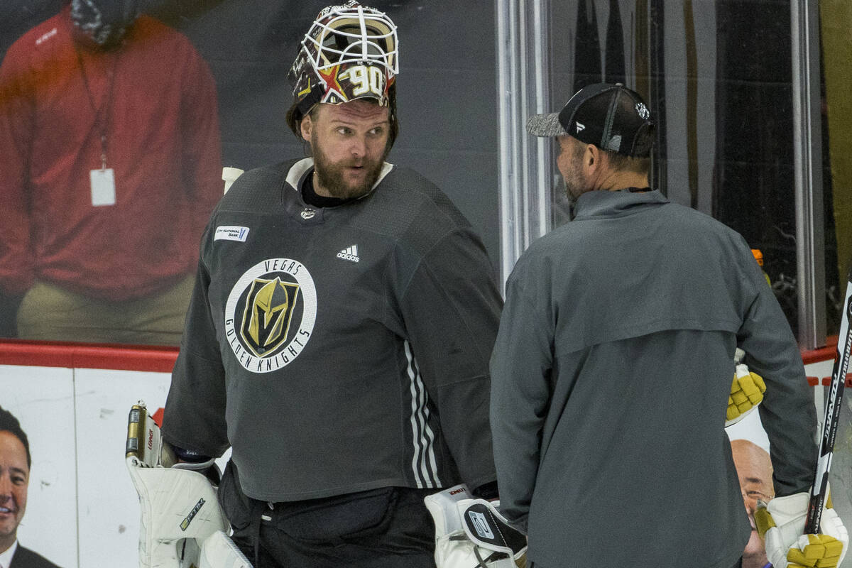 Vegas Golden Knights goaltender Robin Lehner (90, left) talks with head coach Peter DeBoer duri ...