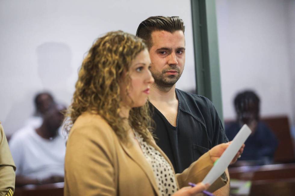 Caleb Rogers, a Las Vegas police officer who is accused of robbing a casino, listens to his att ...