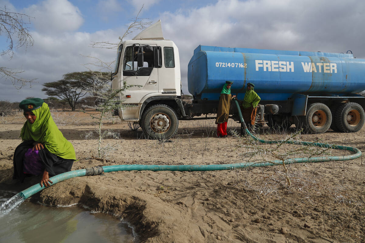 Rangers from the Sabuli Wildlife Conservancy supply water from a tanker for wild animals in the ...