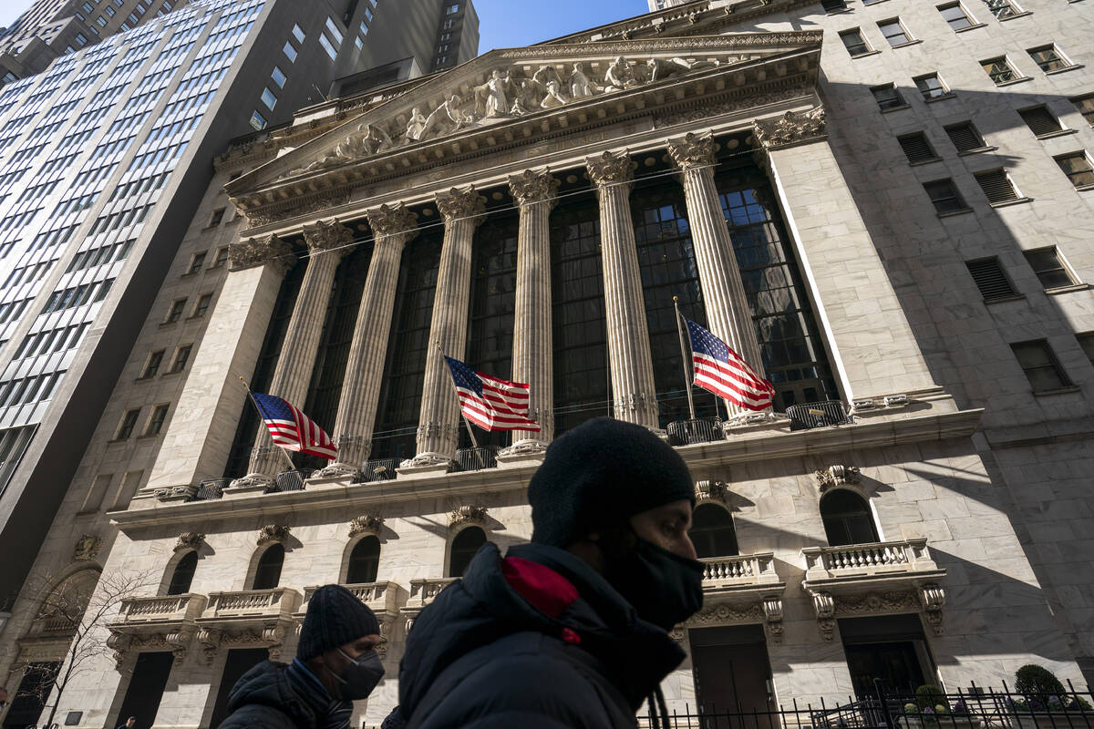 A pedestrian passes the New York Stock Exchange, Monday, Jan. 24, 2022, in New York. (AP Photo/ ...