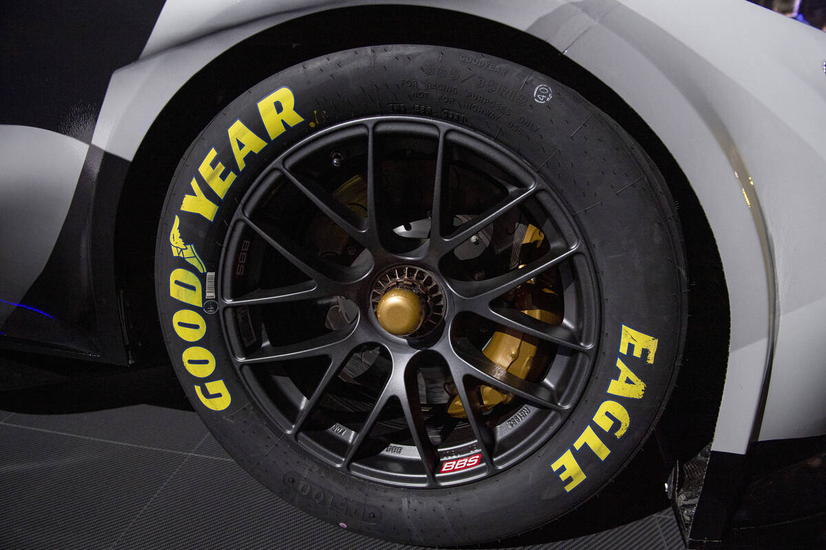 A NASCAR 2022 Next Gen car tire with a single center locking lug is displayed during a media ev ...