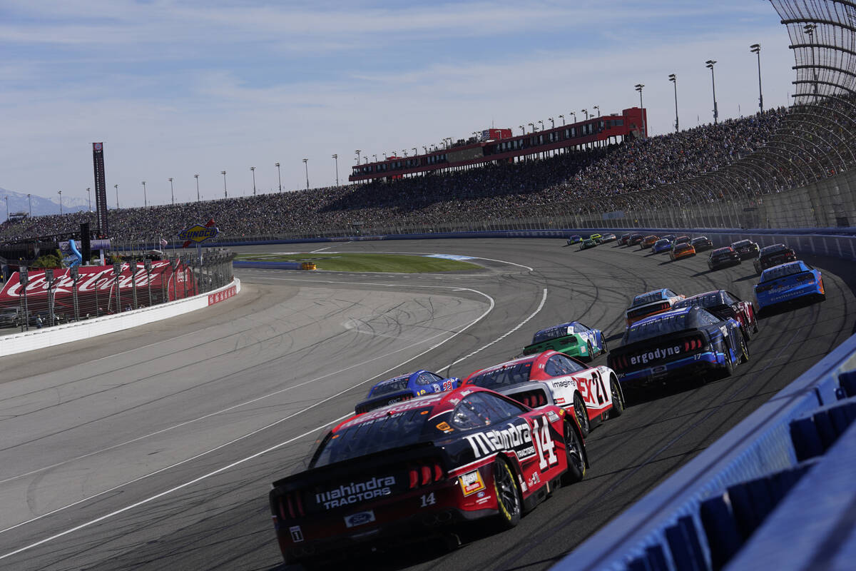 Competitors make a turn during the NASCAR Cup Series auto race at Auto Club Speedway Sunday, Fe ...