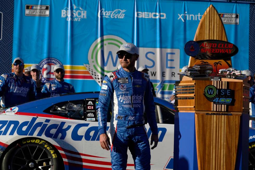 Kyle Larson stands under the podium after winning the NASCAR Cup Series auto race at Auto Club ...