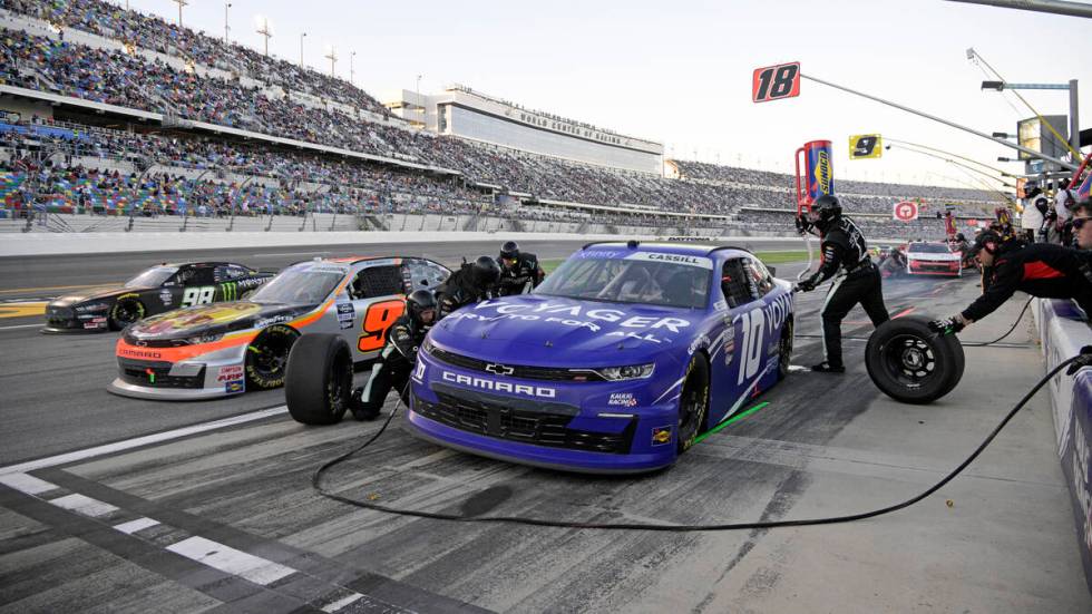 Landon Cassill, right, makes a pit stop for fuel and tires as Noah Gragson (9) and Riley Herbst ...