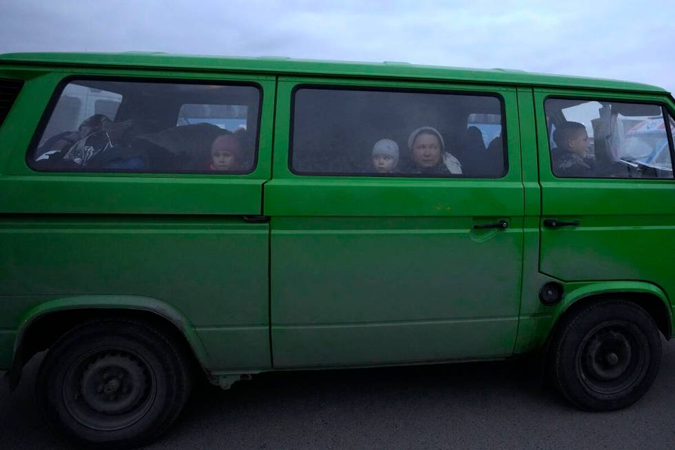 A family from Ukraine arrives at the border crossing in Medyka, southeastern Poland, Wednesday, ...