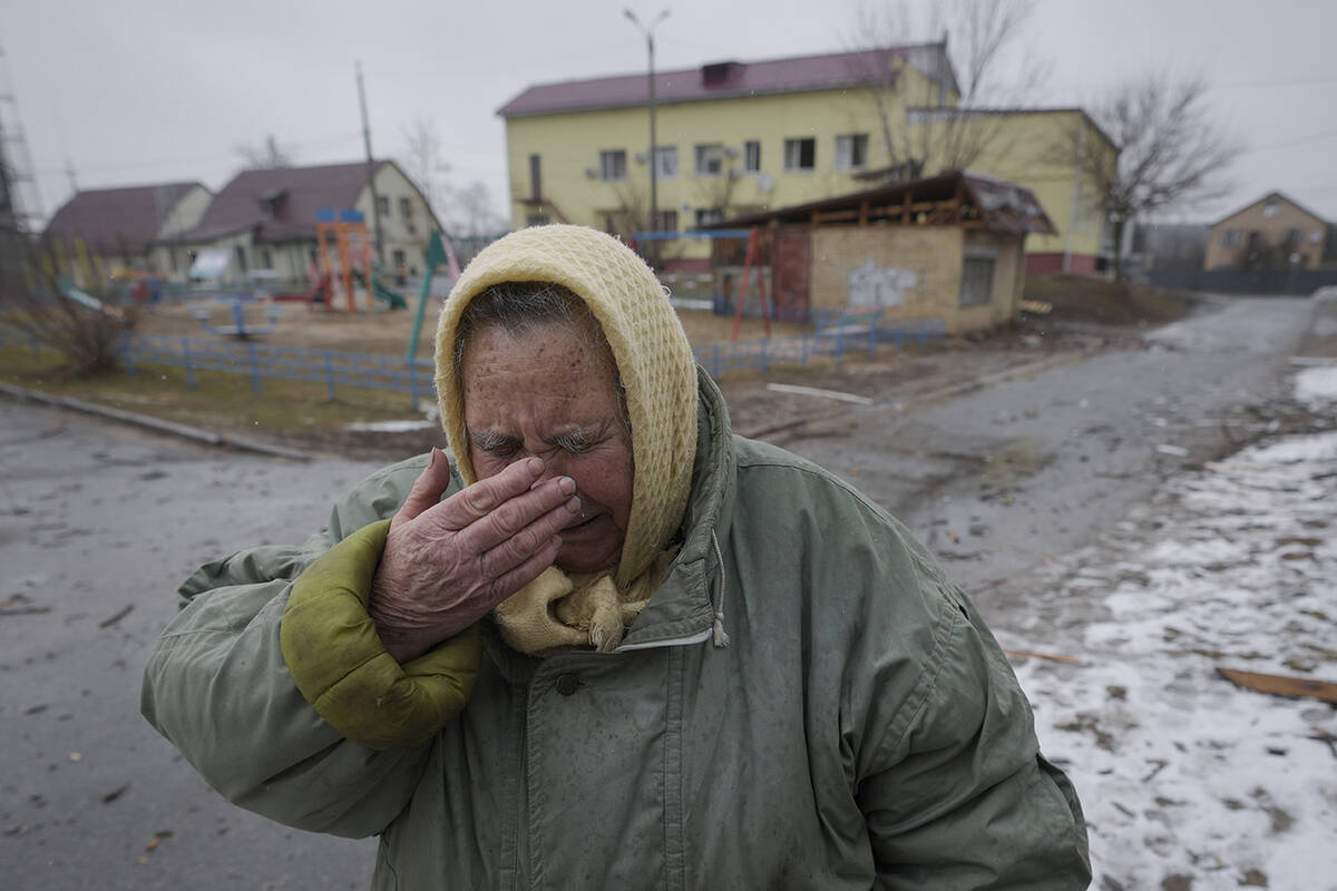 A woman cries outside houses damaged by a Russian airstrike, according to locals, in Gorenka, o ...