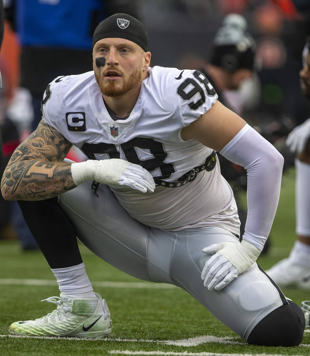 Raiders defensive end Maxx Crosby (98) stretches before an NFL playoff game against the Cincinn ...