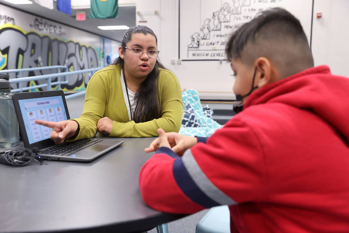 Jerania Mancilla, assistant teacher for resource room, works with third grader Johnny Cano Rive ...