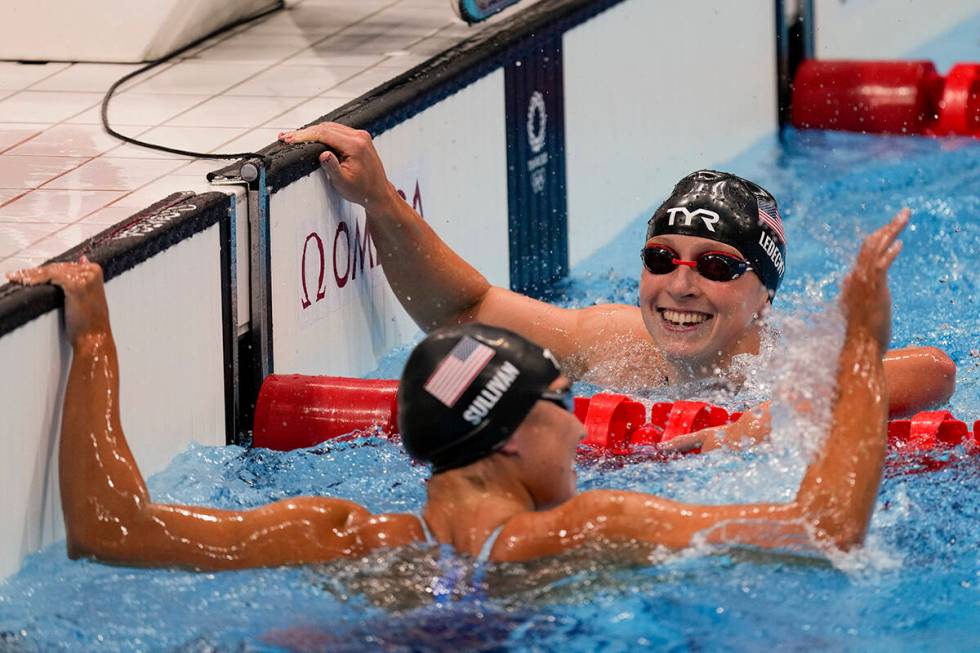 Katie Ledecky, right, of the United States, celebrates after winning the women's 1500-meters fr ...