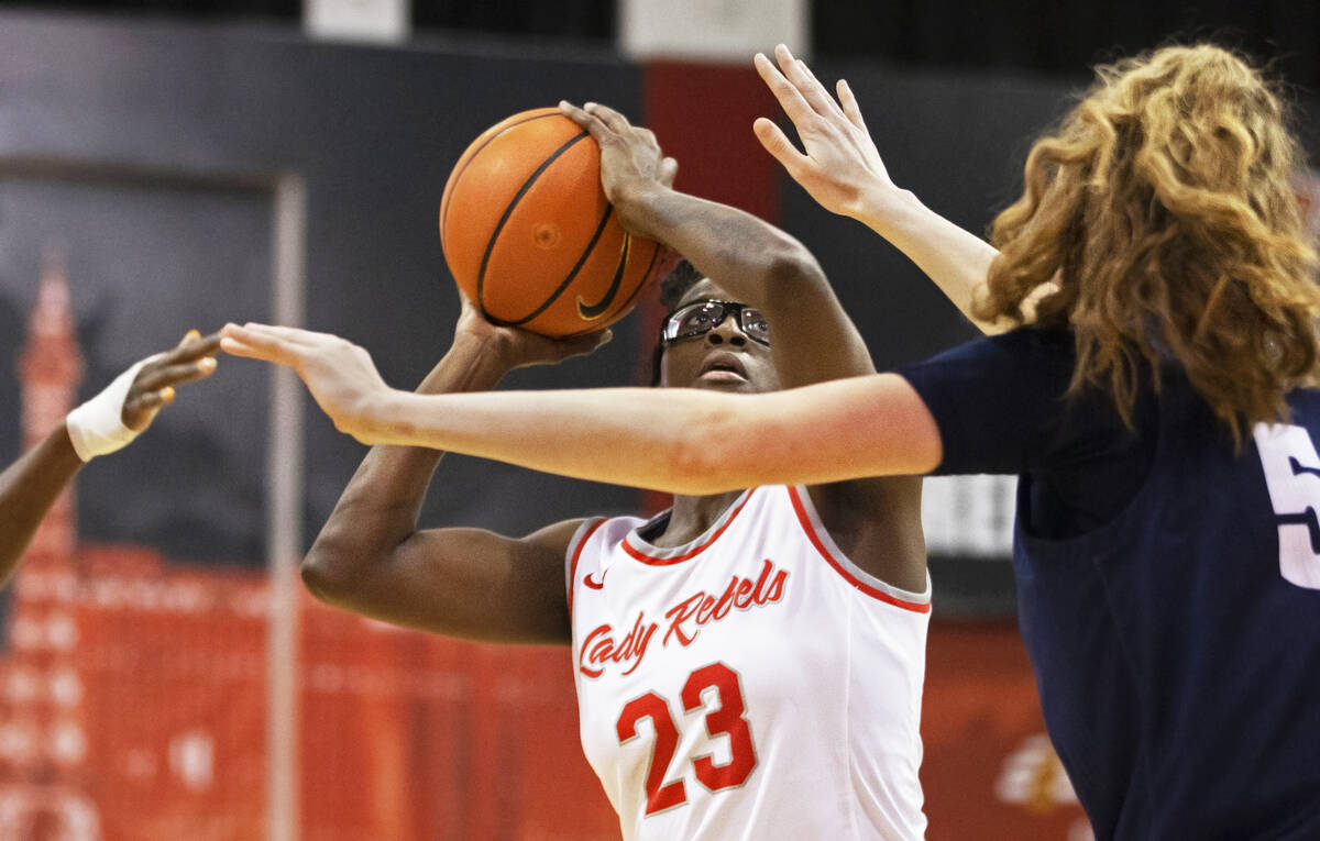UNLV Lady Rebels center Desi-Rae Young (23) shoots over Nevada Wolf Pack forward Natalie Lathro ...