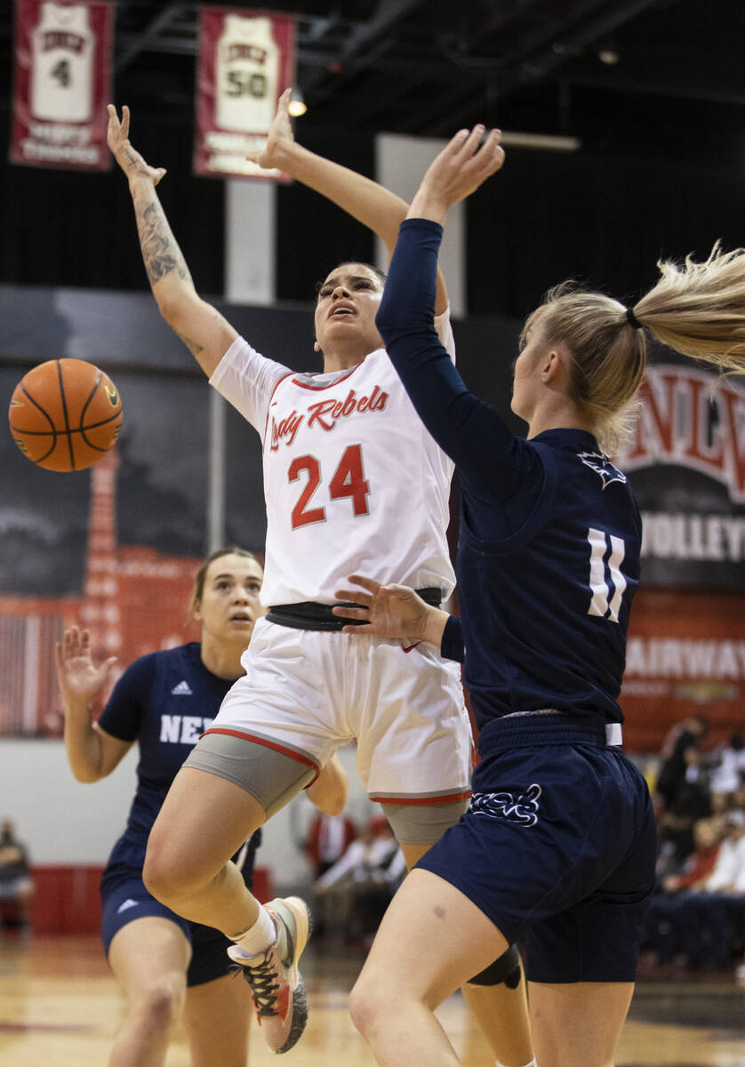 UNLV Lady Rebels guard Essence Booker (24) is fouled on the way to the basket by Nevada Wolf Pa ...