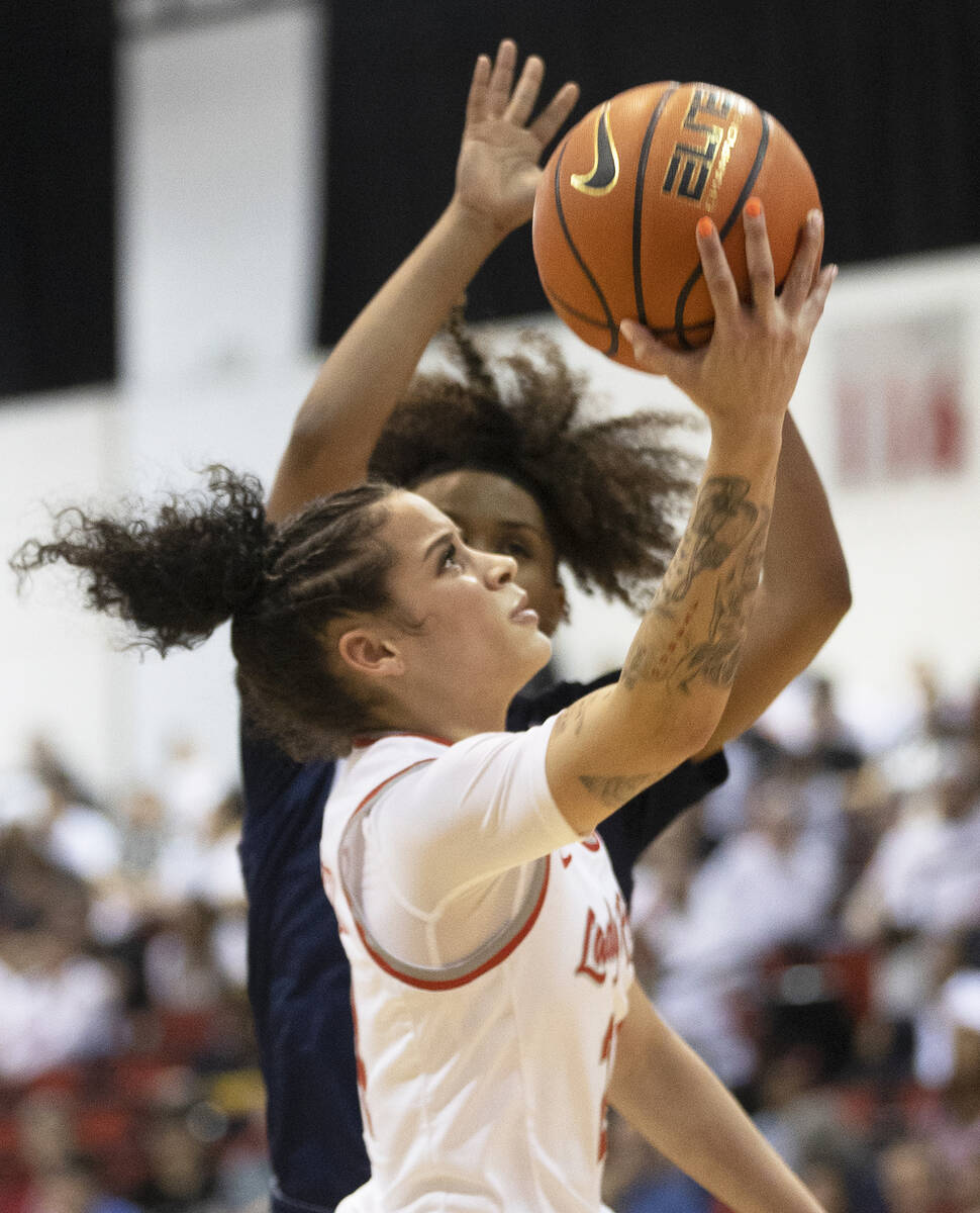 UNLV Lady Rebels guard Essence Booker (24) drives past a Nevada Wolf Pack defender in the secon ...