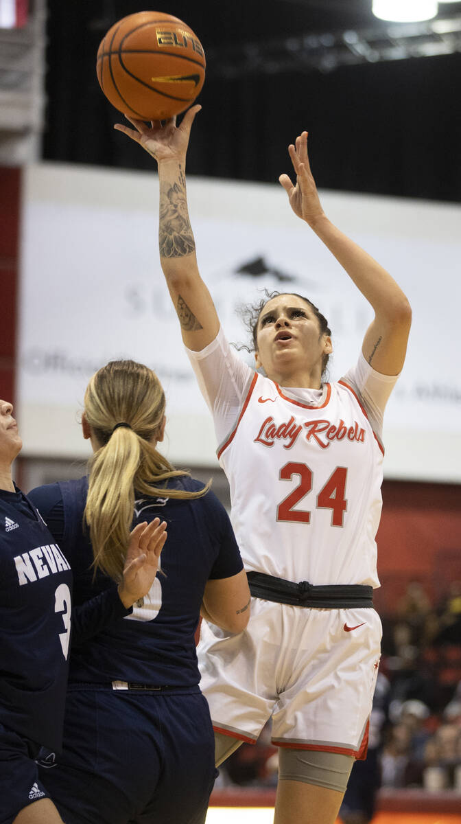 UNLV Lady Rebels guard Essence Booker (24) shoots over Nevada Wolf Pack guard Kaylee Borden (5) ...