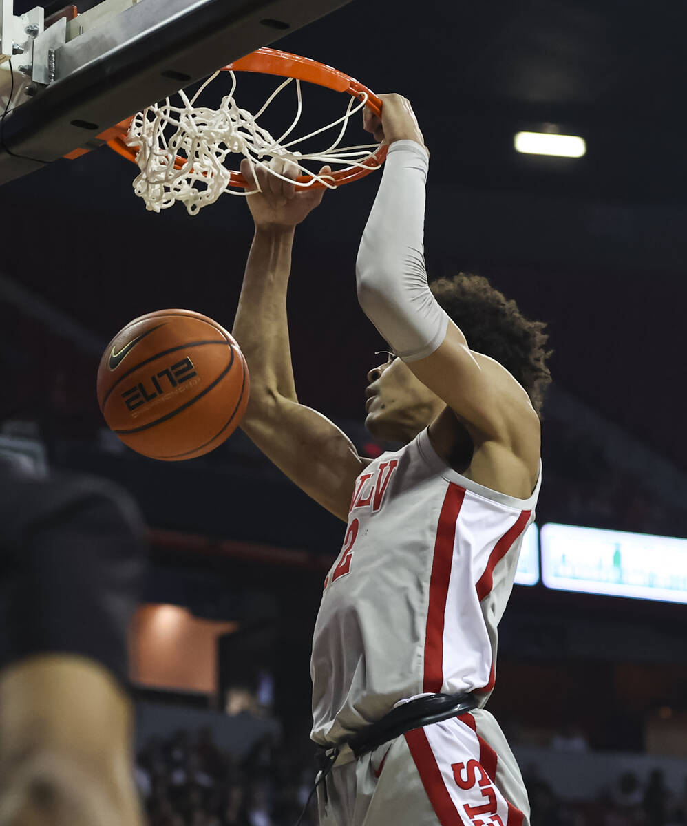 UNLV Rebels center David Muoka (12) dunks the ball against Wyoming during the first half of a b ...