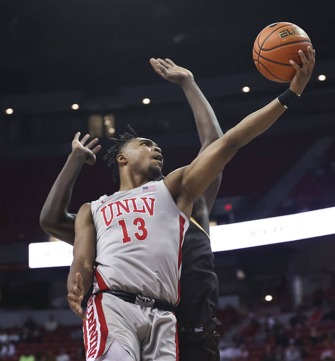 UNLV Rebels guard Bryce Hamilton (13) goes for a layup against the Wyoming Cowboys during the ...