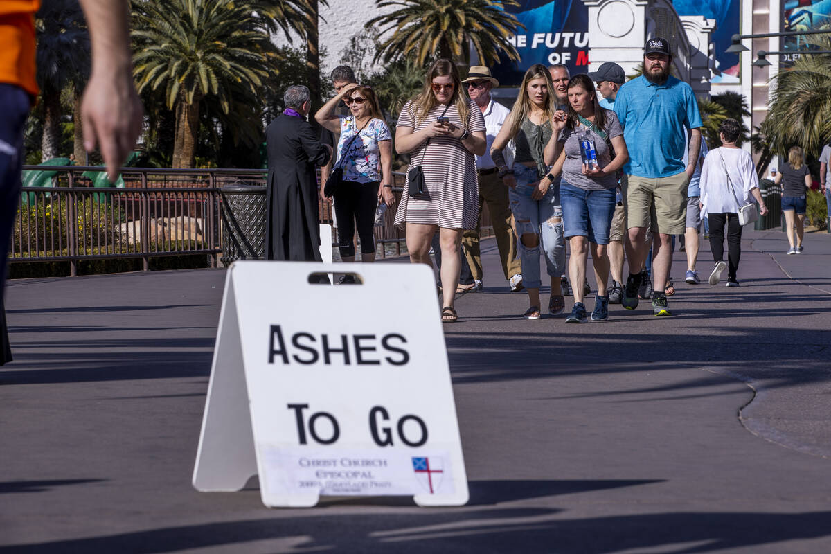 Some passers-by take part during Ashes to Go on Ash Wednesday from Christ Church Episcopal alon ...