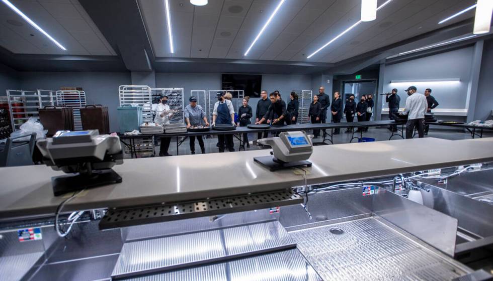 Servers wait in line to pick up desserts within the Event Level Club during a tour of the new D ...