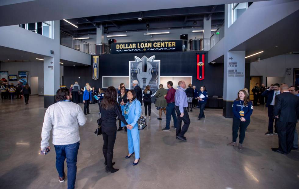 Attendees begin to flow through the entrance of the arena following a ribbon-cutting ceremony f ...