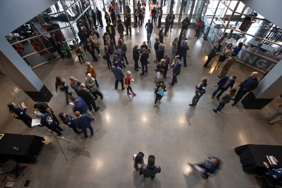 Attendees begin to flow through the entrance of the arena following a ribbon-cutting ceremony f ...