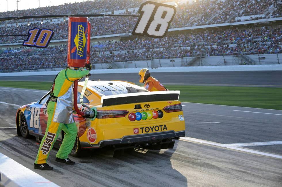 Kyle Busch (18) makes a pit stop during the NASCAR Daytona 500 auto race at Daytona Internation ...
