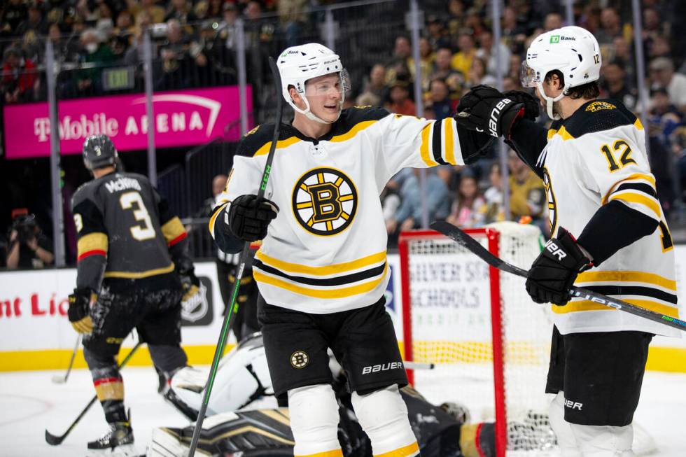 Bruins center Trent Frederic (11) and center Craig Smith (12) celebrate after Smith scored a go ...