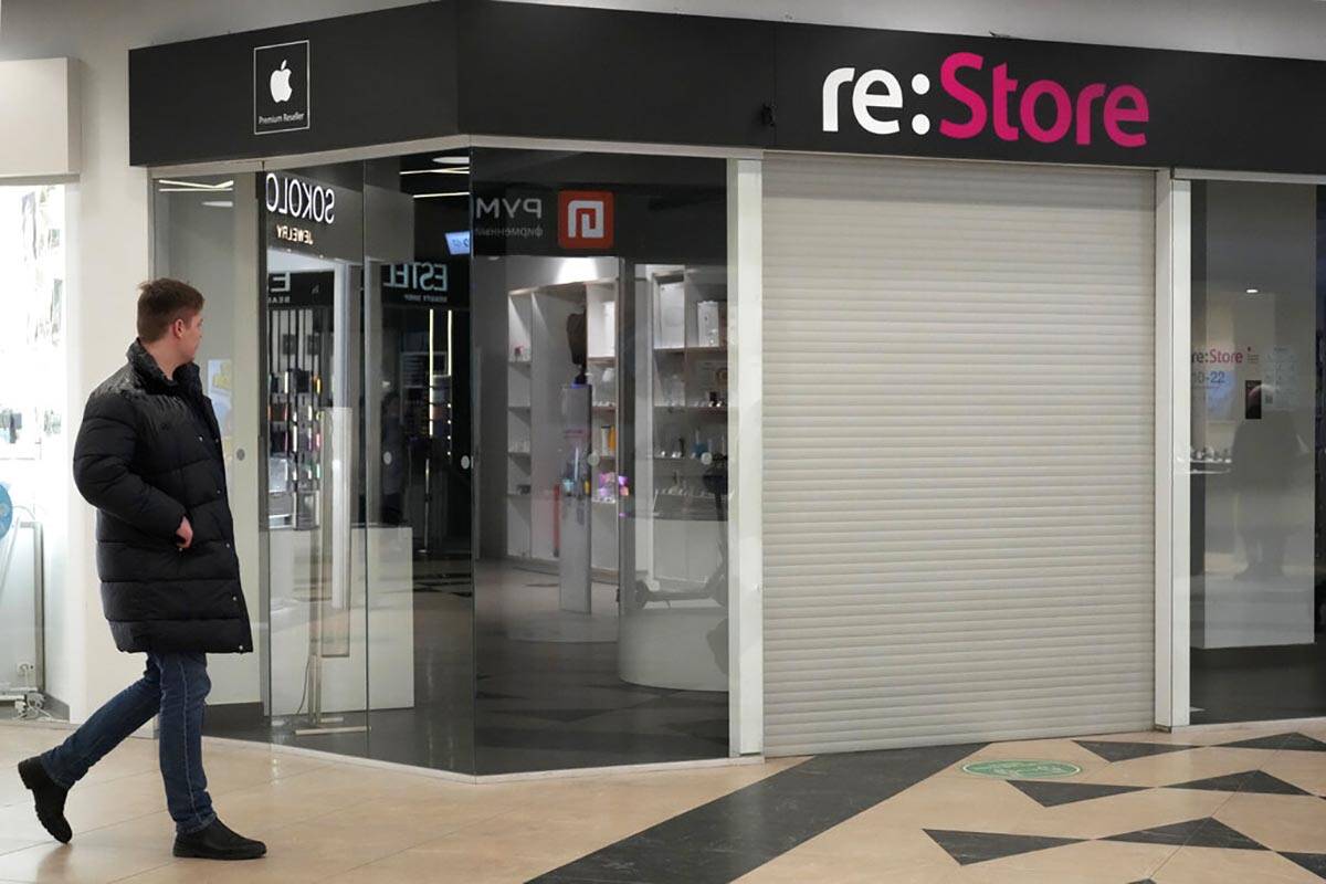 A man walks past a closed 're:Store', an Apple reseller shop at a shopping mall in St. Petersbu ...