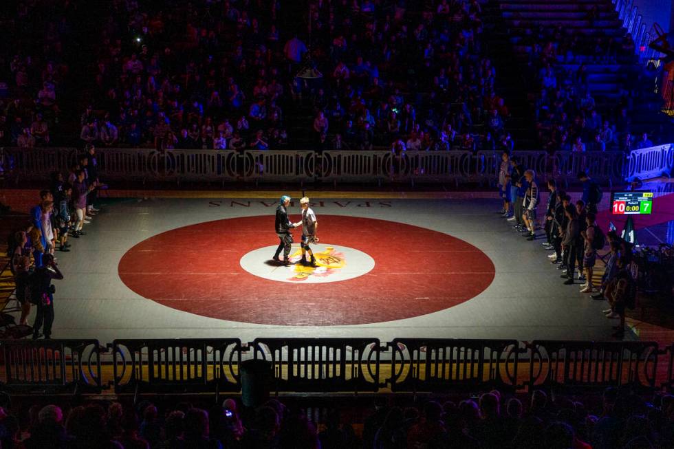 Competitors meet in the center of the mat after being introduced during the 4A state wrestling ...