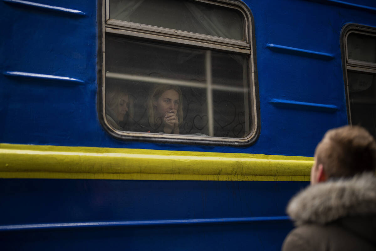 Bogdan, 41, says goodbye to his wife Lena, 35, on a train to Lviv at the Kyiv station, Ukraine, ...