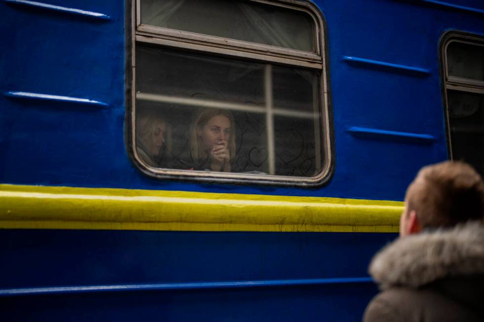 Bogdan, 41, says goodbye to his wife Lena, 35, on a train to Lviv at the Kyiv station, Ukraine, ...