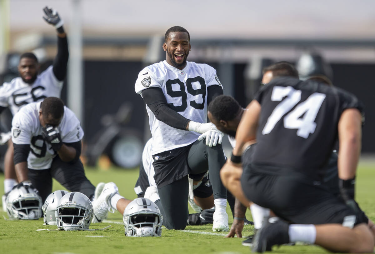 Raiders defensive end Clelin Ferrell (99) smiles while stretching during a practice session at ...