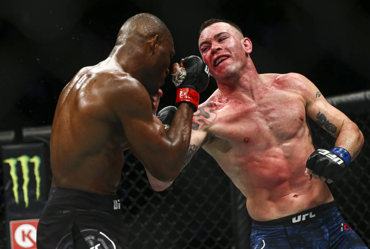 Kamaru Usman, left, fights Colby Covington during their welterweight title boutÊin UFC 245 ...